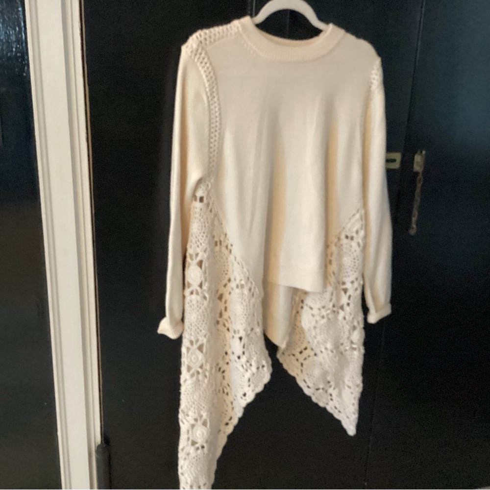 This sweater is aysemetrical crocheted on both sides one side longer
